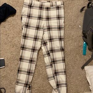 tans black brown and white plaid pants